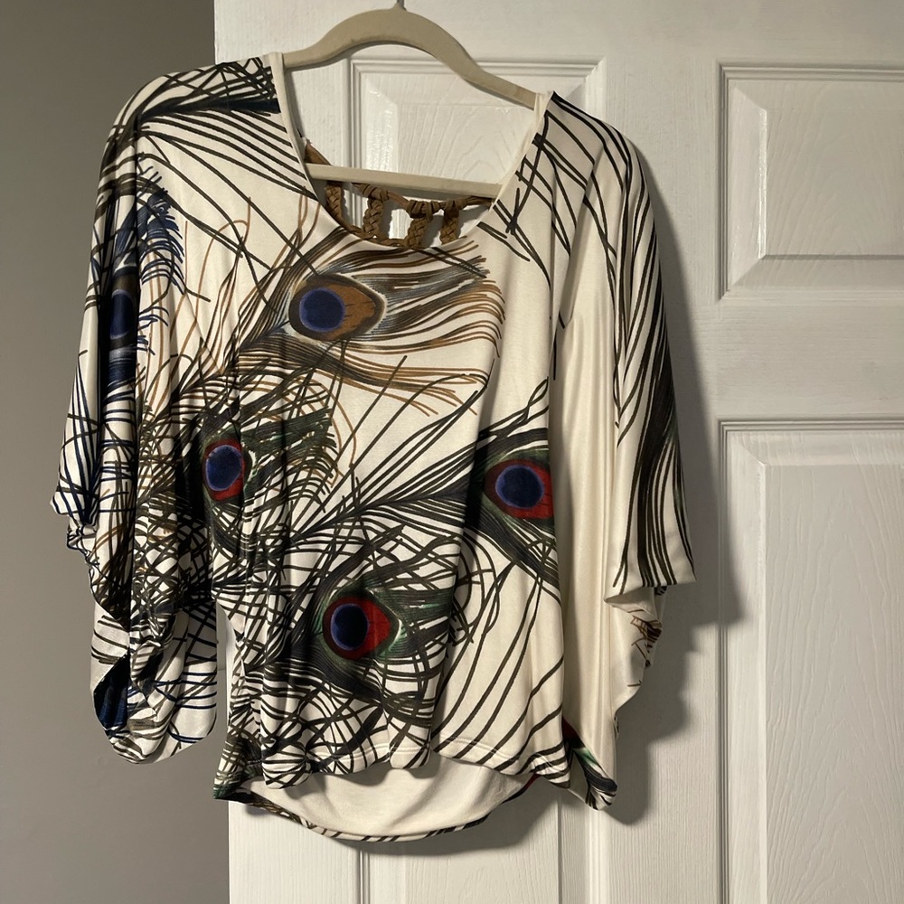 Fun top with wide mid arm bell sleeves.  Open design back.